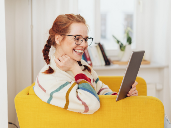 c_canva_Smiling_happy_young_woman_reading_on_a_tablet__stockfour.png